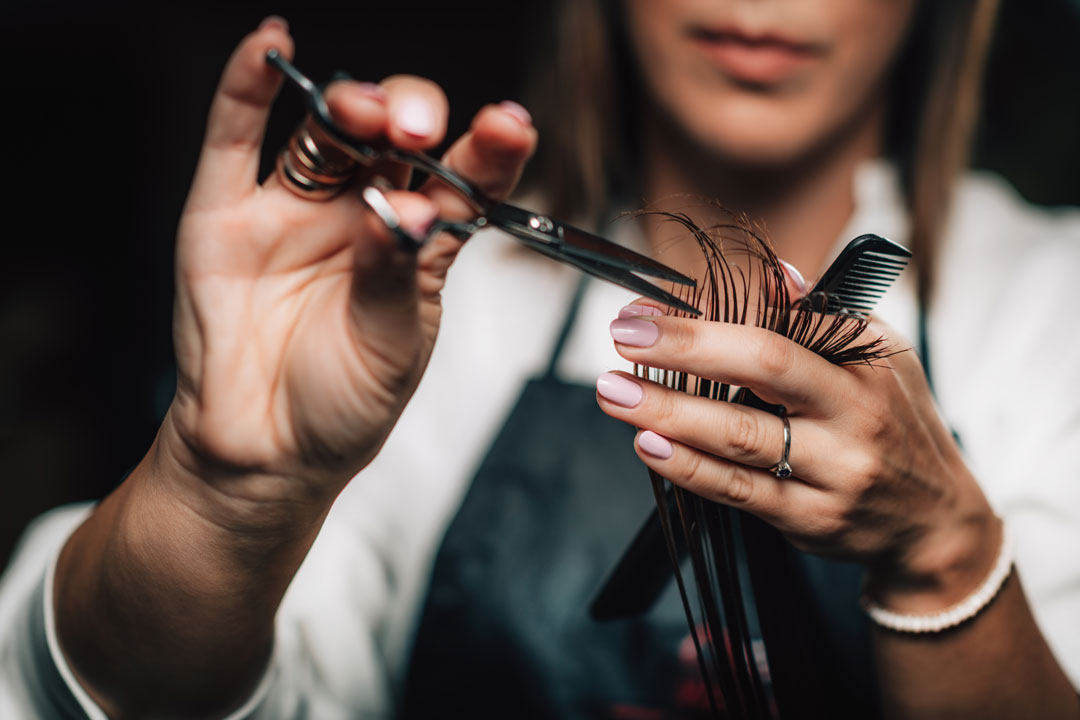 A background image showcasing a hair trim from Lemon Tree Hair Salons.