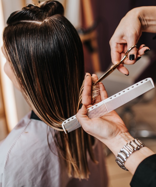 Woman getting her cut at a Lemon Tree Hair Salons - contact us today!